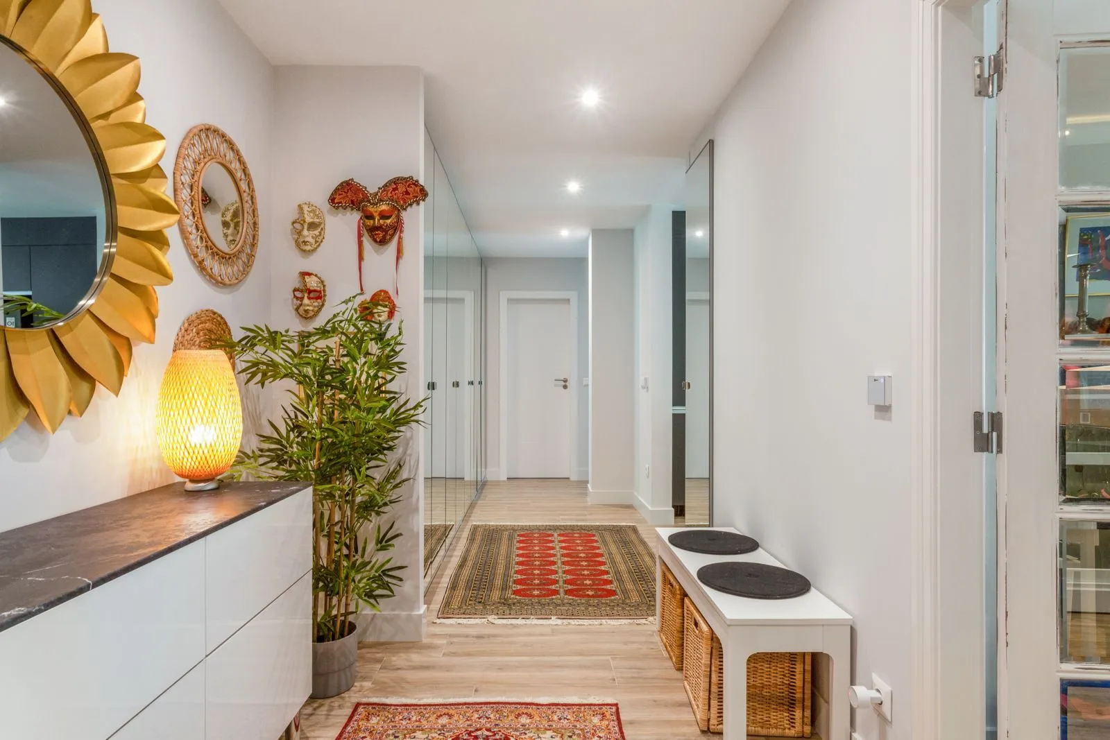 Hallway with decorative masks — Parede renovation by Maya's Homes