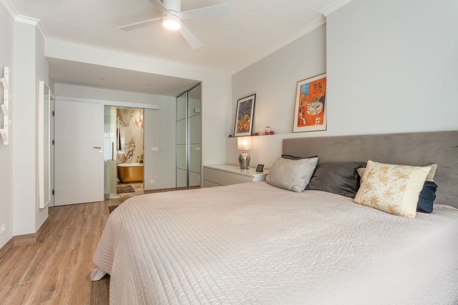 Master suite with gold freestanding bathtub