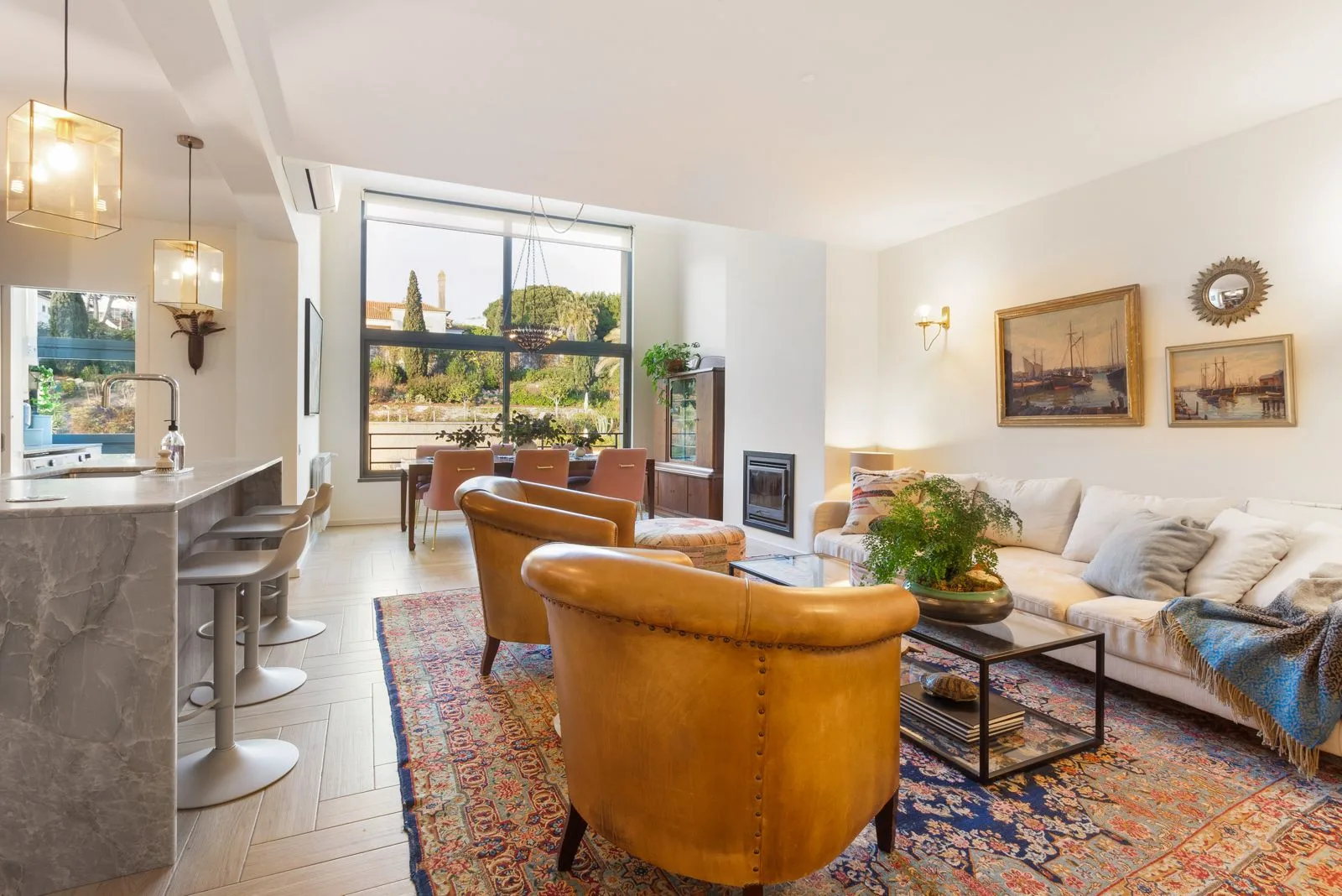 Open-plan living with leather armchairs — Riviera villa by Maya's Homes