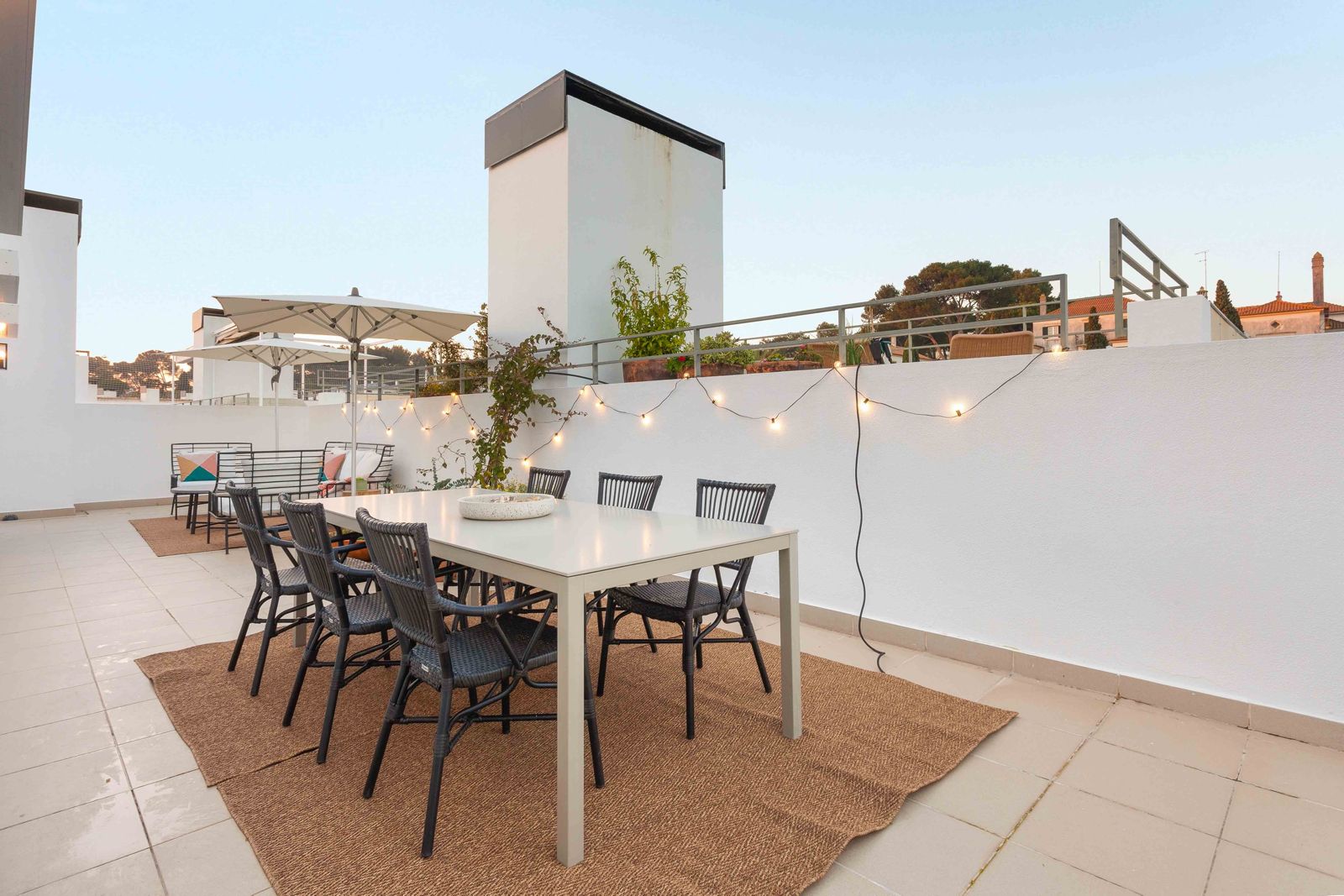 Rooftop terrace with string lights and dining table